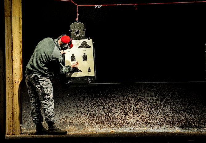 Senior Airman Joshua Lien, 628th Security Forces Squadron Combat Arms Training and Maintenance instructor, tallies up the number of bullets that hit the targets during an M-4 carbine qualifying session at the CATAM firing range, Dec. 12, 2012, on Joint Base Charleston – Air Base, S.C.  Airmen from the 628th SFS participated in the M-4 training overseen by CATM instructors. (U.S. Air Force photo/ Senior Airman Dennis Sloan)
