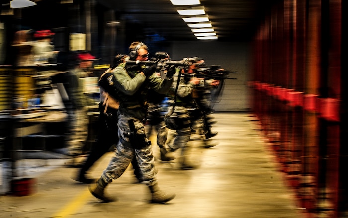Senior Airman Dustin Turner, 628th Security Forces Squadron patrolman, and several other Airmen from the 628th SFS, perform the short range combat portion of the M-4 carbine qualifying session at the Combat Arms Training and Maintenance firing range, Dec. 12, 2012, on Joint Base Charleston – Air Base, S.C. Airmen from the 628th SFS participated in the M-4 training overseen by CATM instructors. (U.S. Air Force photo/ Senior Airman Dennis Sloan)