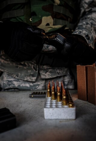 Senior Airman Dustin Turner, 628th Security Forces Squadron patrolman, loads 5.56 millimeter rounds into his magazine during a qualifying session Dec. 12, 2012, at the Combat Arms Training and Maintenance firing range on Joint Base Charleston – Air Base, S.C. The qualifying course tests Airmen’s ability to fire an M-4 carbine from several positions: prone, standing and wearing a gas mask. (U.S. Air Force photo/ Senior Airman Dennis Sloan)