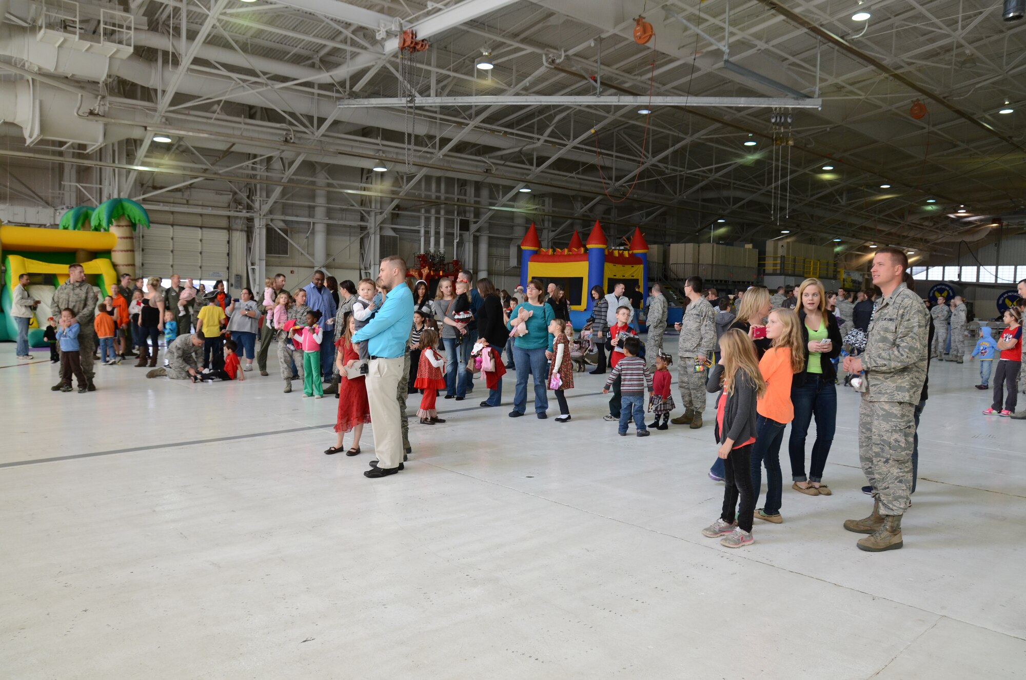 Members of the 126th Air Refueling Wing await the arrival of Santa Claus and his elves in a maintenance hangar during a Kid's Holiday Party. The Illinois Air National Guard unit, located at Scott AFB, Ill., hosted the party for Wing members and their children. The special famiiy time included crafts, games, bouncy houses and a visit from Santa Claus and his elves who arrived on a KC-135R Stratotanker. (National Guard photo by Airman First Class Elise Stout)