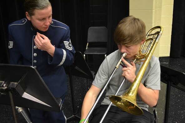 Tech. Sgt. Heather Kirschner, euphonium and trombone player, Band of the U.S. Air Force Reserve, teaches a North Cobb High School Band student breathing techniques during a music clinic on Dec. 12, 2012.  The clinic provided students with different performance and delivery techniques, ways to listen while rehearsing a piece in a small group, and the requirements for being an Air Force musician. (U.S. Air Force photo/Chandra Brown)