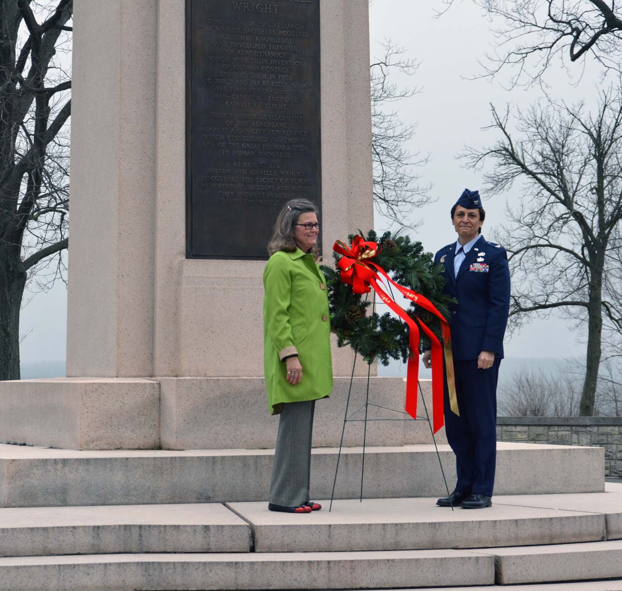 WRIGHT-PATTERSON AIR FORCE BASE, Ohio - Amanda Wright Lane, great grand niece of the Wright brothers and Col. Cassie Barlow, 88th Air Base Wing and Installation Commander, lay a wreath at the Wright Brothers memorial during the Dec. 17, 2012, 109th anniversary ceremony commemorating the Wright brothers’ first successful powered flight at Kitty Hawk, N.C. Lt. Col. Eric Piel, 89th Airlift Squadron pilot, was the keynote speaker (U.S. Air Force photo/Stacy Vaughn)