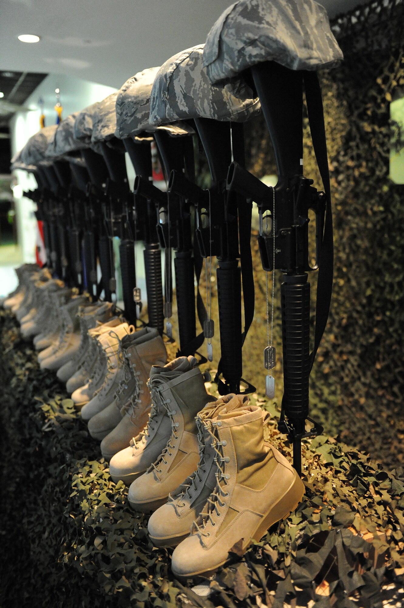 Fallen Soldier Battle Crosses, set up by the organizers of the 2012 Pacific Air Forces Warfighter Conference, were made up of rifles, helmets, dog tags, and the boots of the fallen warriors. The crosses were designed to show honor and respect for fallen service members during the 2012 Pacific Air Forces Commanders and Command Chiefs Warfighter Conference at the Hickam Officers’ Club, at Joint Base Pearl Harbor-Hickam, Hawaii, Dec. 12, 2012. (U.S. Air Force photo/Tech. Sgt. Jerome S. Tayborn)