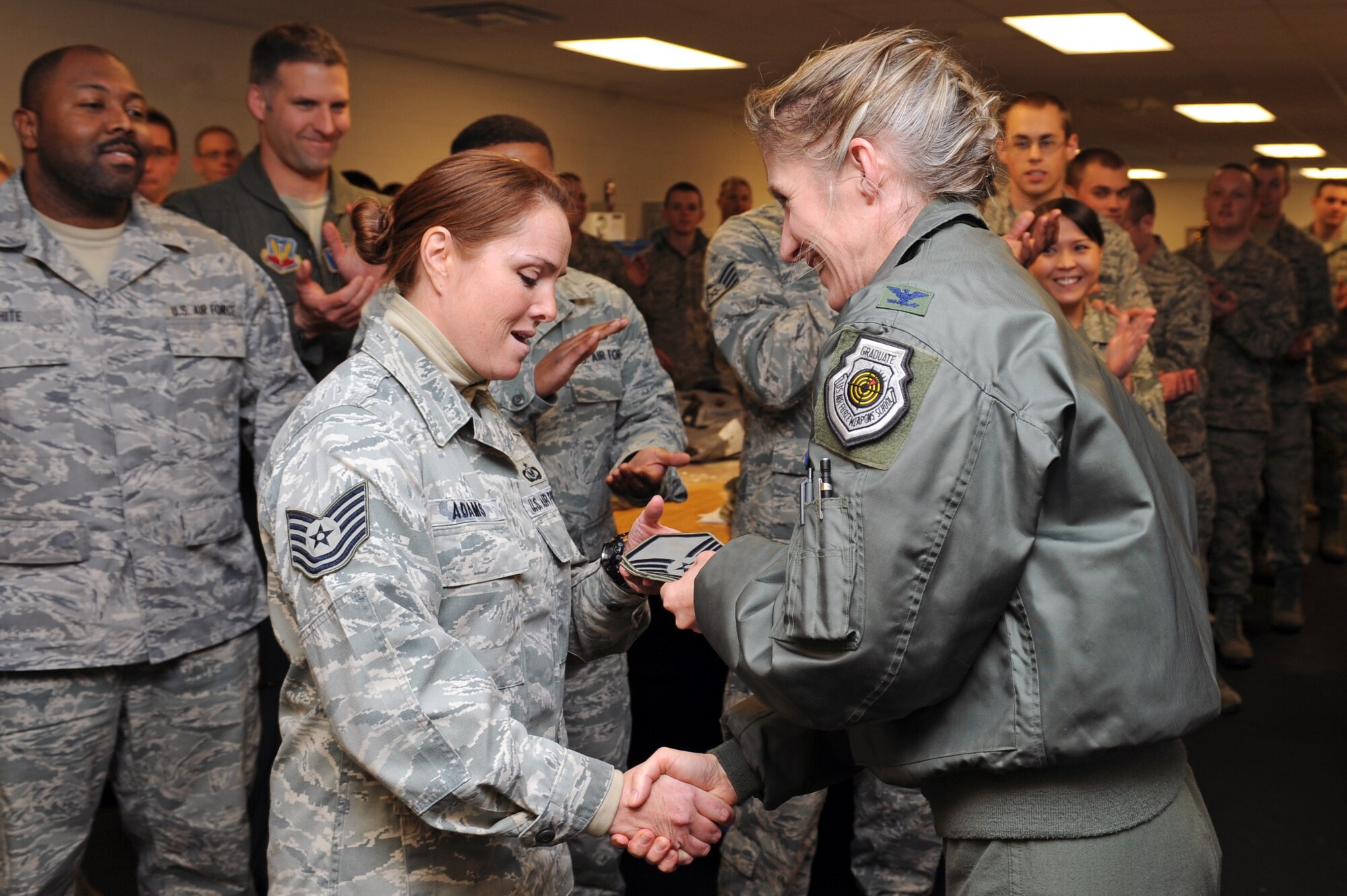 U.S. Air Force Col. Jeannie Leavitt, 4th Fighter Wing commander, promotes Tech. Sgt. Daphne Adams, 4th Operations Support Squadron aircrew flight equipment flight chief, to the rank of master sergeant through the Stripes for Exceptional Performers program on Seymour Johnson Air Force Base, N.C., Dec. 13, 2012. Adams garnered many accolades leading to the promotion including being named 2011 4th FW NCO of the Year. (U.S. Air Force photo/Airman 1st Class John Nieves Camacho/Released)