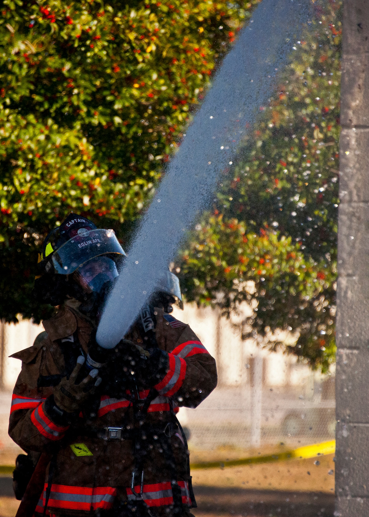 A firefighter with the 96th Civil Engineer Squadron, sprays down the roof of a building during a structural live-fire training exercise at Eglin Air Force Base, Fla., Dec. 13. The building used for the training was scheduled to be demolished Dec. 19. (U.S. Air Force photo/Samuel King Jr.)