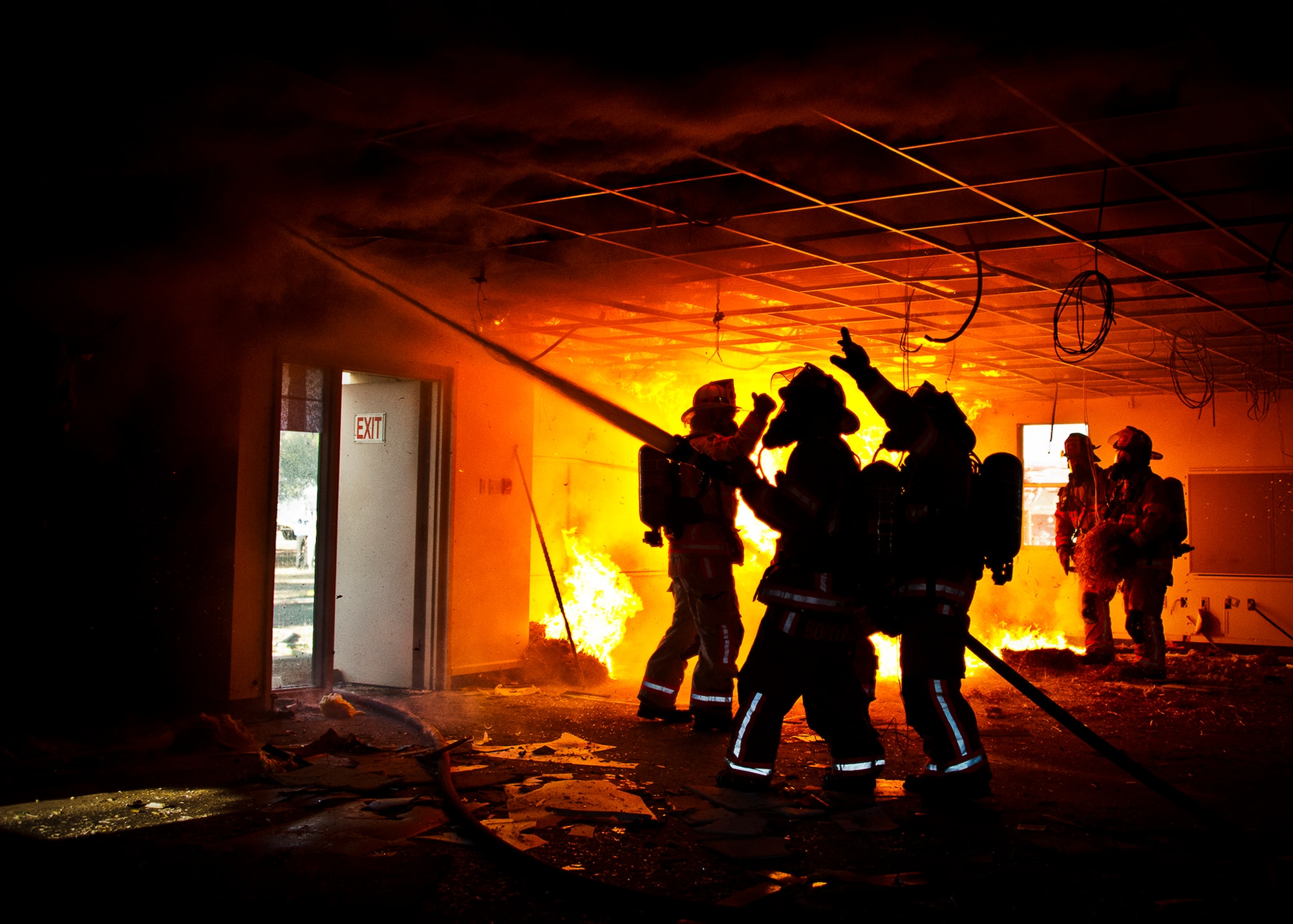 Firefighters spray down the ceiling as the Fire Chief Mark Giuliano orders everyone out of the building during a live-fire training exercise at Eglin Air Force Base, Fla., Dec. 13.  The building used for the training was scheduled to be demolished Dec. 19. (U.S. Air Force photo/Samuel King Jr.)