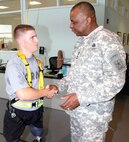 Photo by Robert Shields
Army Vice Chief of Staff Gen. Lloyd J. Austin III coins Army Sgt. Ian Parkinson during his visit to the Center for the Intrepid Dec. 3. Austin visited with wounded warriors after a Purple Heart ceremony held the same day.
