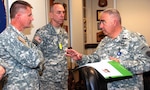 Photo by Robert R. Ramon
Brig. Gen. Orlando Salinas (right), U.S. Army South deputy commanding general, speaks to Col. David Boyle (center), Missouri Army National Guard chief of staff and Brig. Gen. Randy Alewel (left), 35th Engineer Brigade commanding general, at the Army South headquarters.
