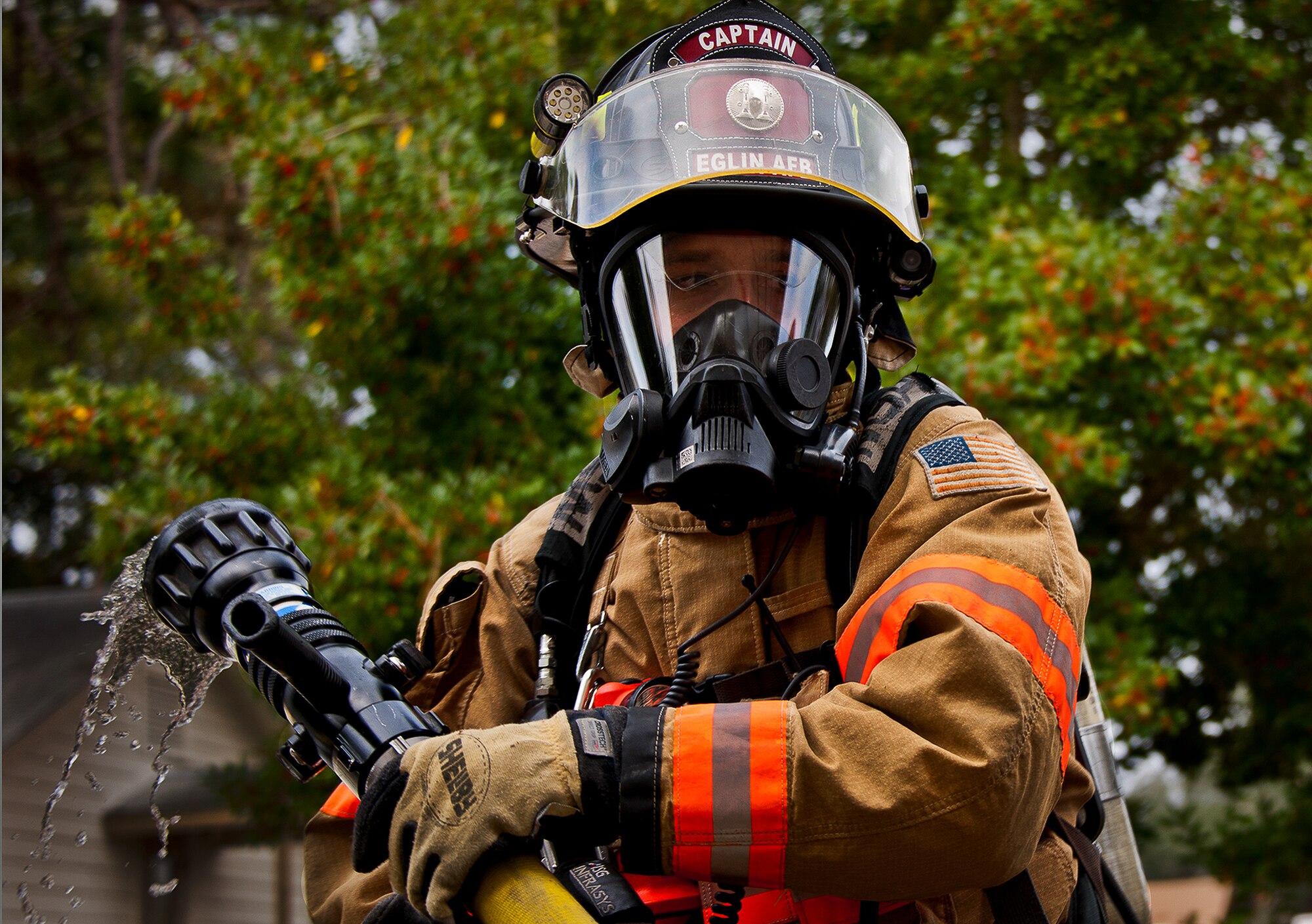 Staff Sgt. Michael Fularz, a firefighter with the 96th Civil Engineer Squadron, moves the hose into place before entering the building to begin the structural live-fire training exercise at Eglin Air Force Base, Fla., Dec. 12.  Two-person teams entered a building on fire and demonstrated hose and various firefighting procedures while engaging the controlled blaze.  (U.S. Air Force photo/Samuel King Jr.)