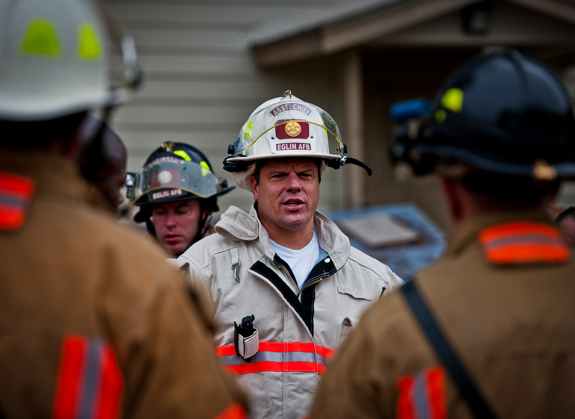 Kevin Remedies, the base assistant fire chief, briefs his firefighters after completing the structural live-fire training exercise at Eglin Air Force Base, Fla., Dec. 12.  Two-person teams entered a building on fire and demonstrated hose and various firefighting procedures while engaging the controlled blaze.  (U.S. Air Force photo/Samuel King Jr.)