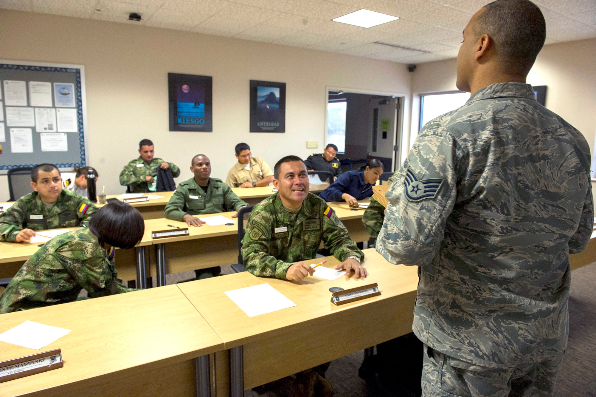 Staff Sgt. Jaime Torres, USAF instructor at the Inter-American Air Forces Academy, prepares students for their final exam in the International Logistics course, Joint Base San Antonio-Lackland, TX, Dec. 7, 2012. Thirteen partner nation students from Colombia, Dominican Republic, Panama, Ecuador, and Uruguay attended the International Logistics course during the last semester of 2012. The International Logistics course focuses on joint logistics principals, security cooperation and foreign military sales.    (US Air Force Photo by Staff Sgt. Marleah Miller)