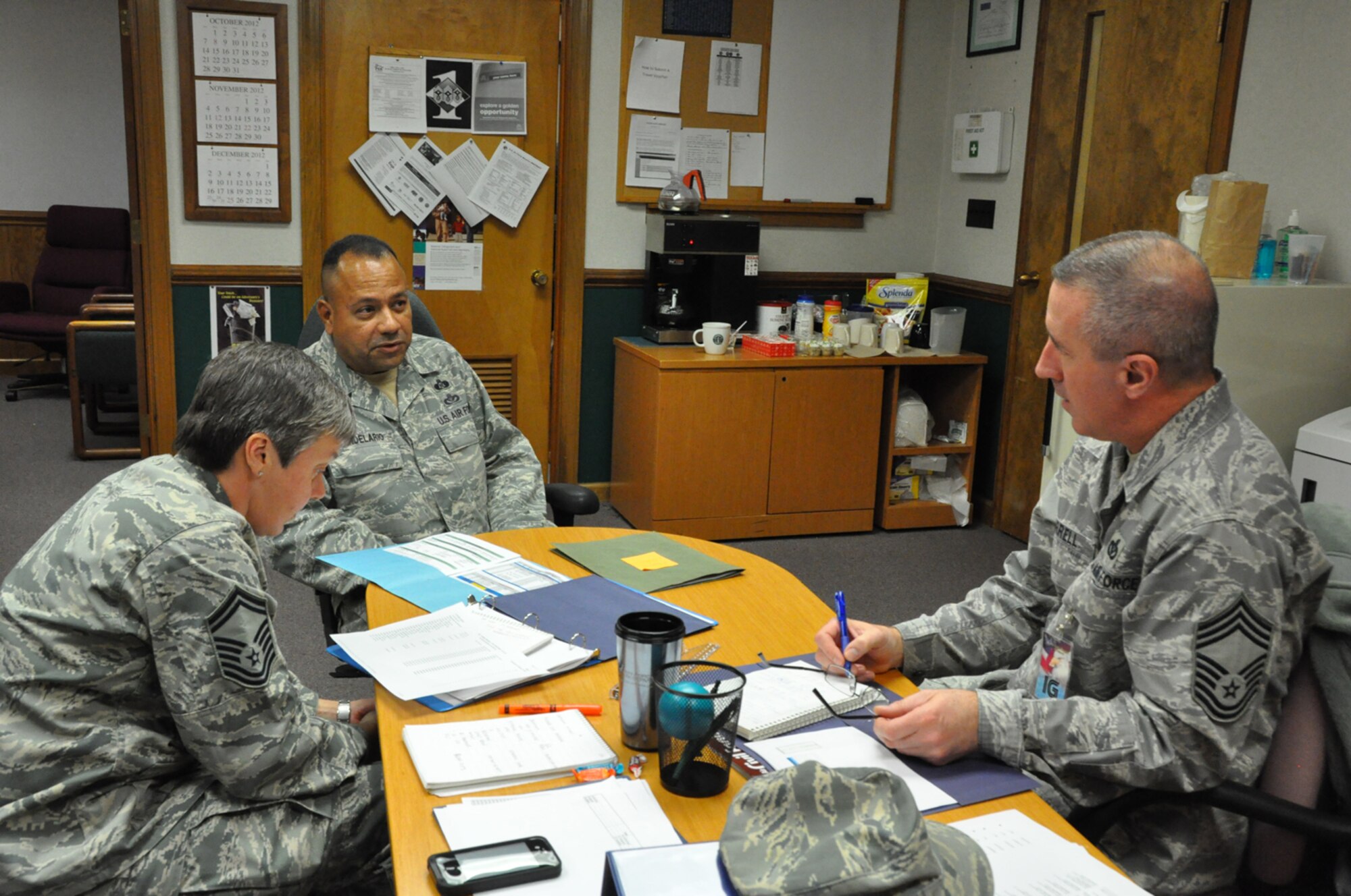 Senior Master Sgt. Ivan Candelario (center), talks to members of the Air Force Reserve Command Inpsector General team about programs in the 916th Civil Engineer Flight. Four major inspections took place Dec. 11-18, 2012. (USAF photo by MSgt. Wendy Lopedote, 916ARW/PA)