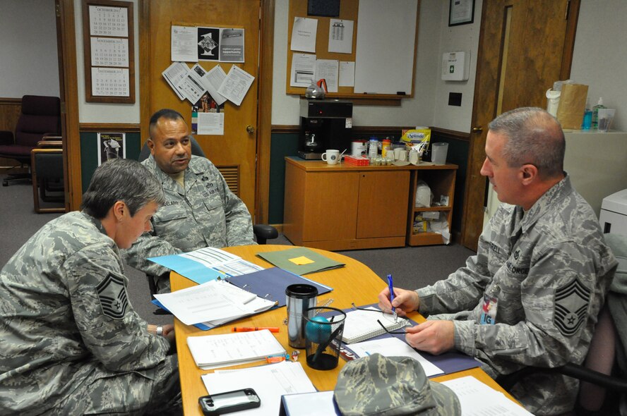 Senior Master Sgt. Ivan Candelario (center), talks to members of the Air Force Reserve Command Inpsector General team about programs in the 916th Civil Engineer Flight. Four major inspections took place Dec. 11-18, 2012. (USAF photo by MSgt. Wendy Lopedote, 916ARW/PA)