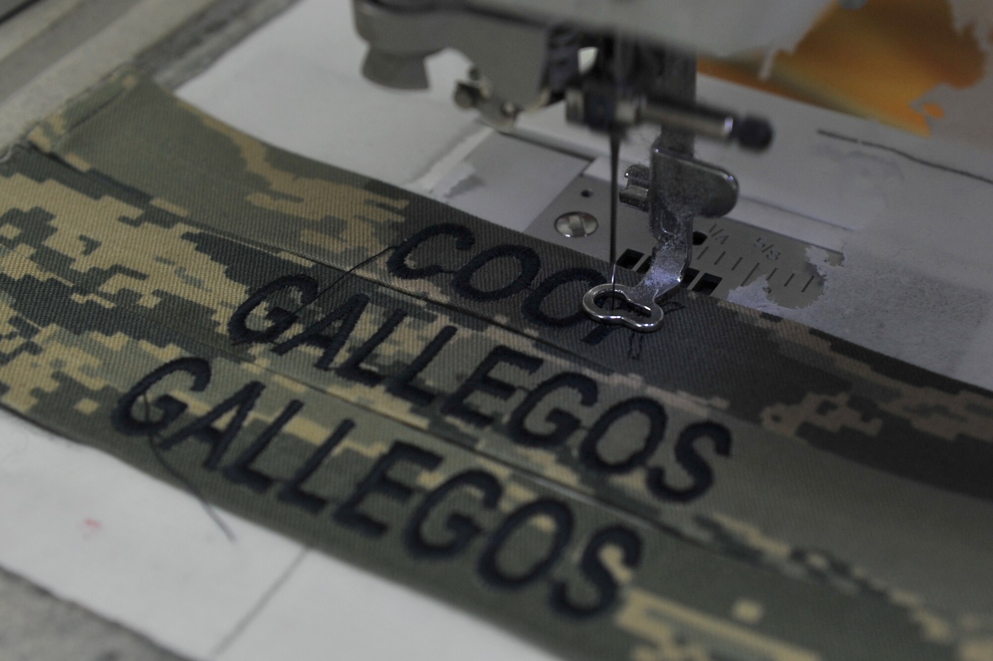 Dhiaa Zeidlr, owner of Bablon Alterations, embroiders names on name tapes for Air Force uniforms at his shop on Ramstein Air Base, Germany, Dec. 14, 2012. The alterations shop serves more than 54,000 members of the Kaiserslautern Military Community. (U.S. Air Force photo/Airman 1st Class Holly Cook)
