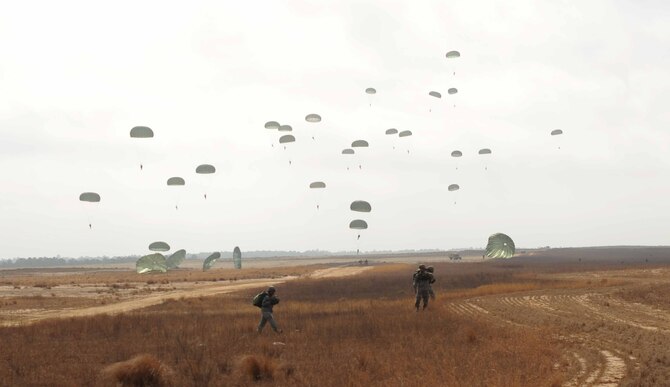 U.S. Army paratroopers exfill the Sicily drop zone after jumping from an aircraft during Operation Toy Drop 2012 at Fort Bragg, N.C., Dec. 8, 2012. 2012 marks the 15th year for the Randy Oler Memorial Operation Toy Drop which collects toy donations for children and families in need and gives paratroopers the opportunity to jump with foreign jumpmasters. Soldiers donate a new toy in exchange to jump with a foreign jumpmaster and earn foreign jump wings. This year, OTD has expanded from its traditional focus around Fort Bragg, N.C. to select cities around the country. OTD is a Fort Bragg airborne tradition. Operation Toy Drop combines thousands of toys, Army paratroopers, hundreds of volunteers, dozens of allied military personnel, and more than a dozen Air Force aircraft, all for what has become the world's largest combined airborne operation.(U.S. Air Force photo by Airman 1st Class Jasmonet Jackson)