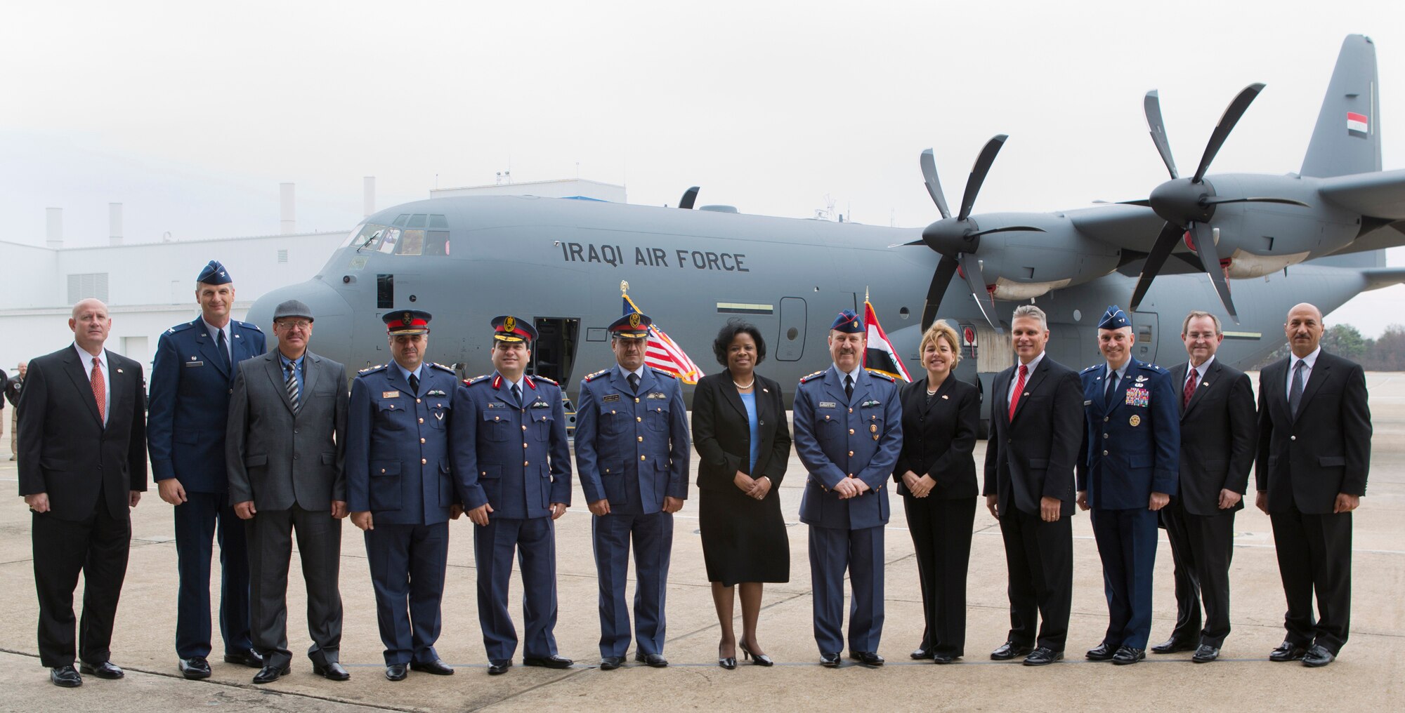 Iraqi officials, Lockhead Martin Senior Leaders and Air Force leaders pose for a picture in front of the C-130J that will be delivered to Iraq from Marietta, GA, Dec 12, 2012. From left to right: Jack Crisler, Lockheed Martin Vice President Business Development, Colonel John Drohan, DCMA Commander Marietta, Iraqi Interpreter, Staff Colonel, Sameer Fareed, Abdul Hameed, C-130 Command Pilot, Staff Brigadier General Ali Alaaragy, Iraqi Defense Attaché in Washington, DC, Staff Brigadier General Mohammed Abdulkareem Awni AL-SAADI, New Al Muthana Air Base Commander, Shan Cooper, Lockheed Martin Vice President and Site General Manager Marietta, Staff Lt. Gen. Anwer Hamad Amen, Iraqi Air Force Commander, Heidi Grant, Deputy Under Secretary of the U.S. Air Force, International Affairs George Shultz, Lockheed Martin Vice President and General Manager C-130 Programs, Major General Frederick Martin, OSC-1 , George Standridge, Lockheed Martin Vice President Business Development, Lt. Col. Hamid Madab Hussien Al-Imara. (Courtesy photo by Lockhead Martin’s Damien A. Guarnieri)
