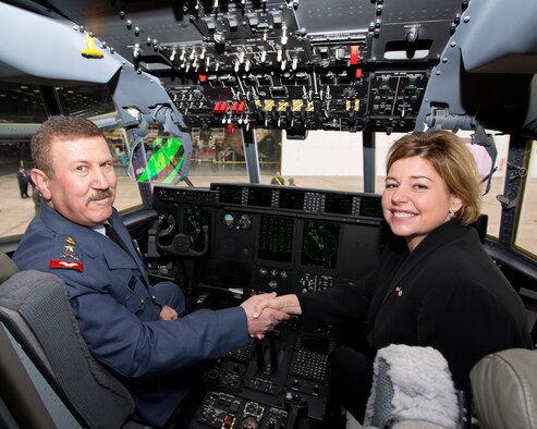Staff Lt. Gen. Anwer Hamad Amen, Iraqi Air Force Commander, shakes hands with Heidi Grant, Deputy Under Secretary of the U.S. Air Force, International Affairs, in the cockpit of the Iraqi Air Force's C-130J number three in Murietta, GA, Dec.12, 2012. (Courtesy photo by Lockhead Martin’s Damien Guarnieri)