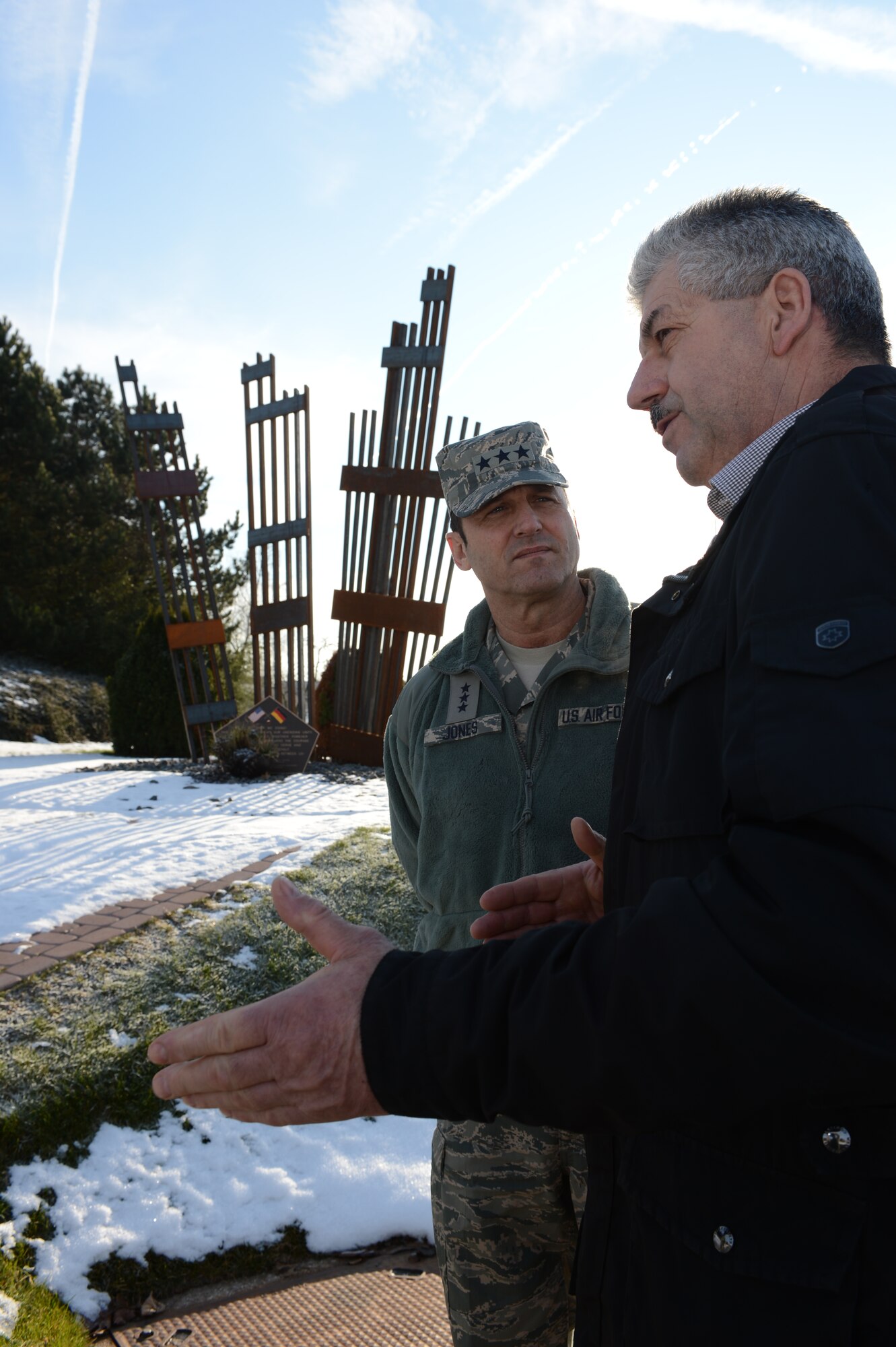 SPANGDAHLEM AIR BASE – U.S. Air Forces in Europe Vice Commander Lt. Gen. Tom Jones, talks with Spangdahlem Mayor Klaus Rodens during a familiarization tour Dec. 13, 2012. Jones and Rodens talked about the relationship between the 52nd Fighter Wing and the community. The newest addition to the Spangdahlem Air Park is the Sept. 11 memorial, created by a local artist. He, with the help of the local host nation council, donated the artwork to the wing. (U.S. Air Force photo by Senior Airman Natasha Stannard /Released)