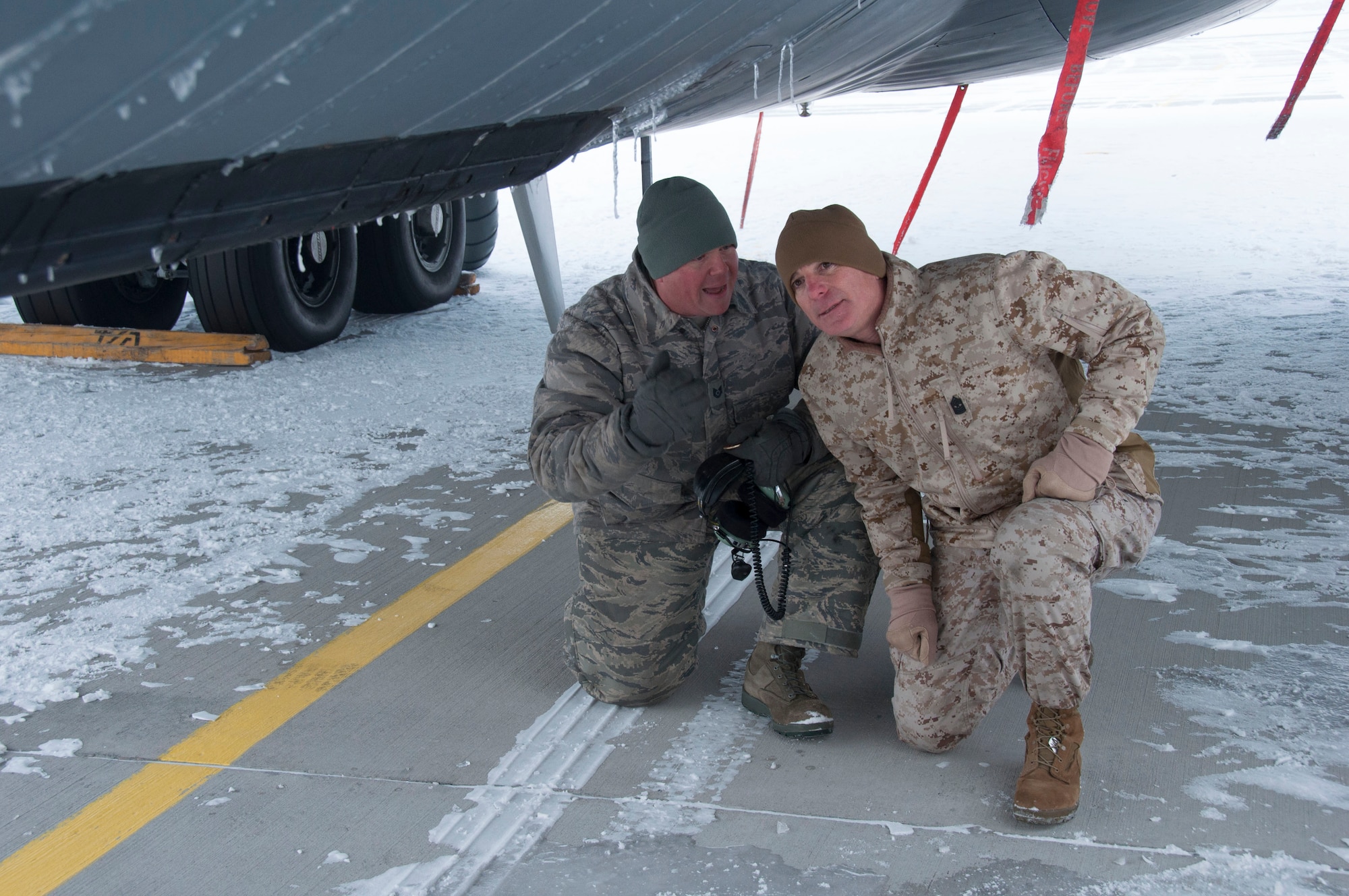Tech. Sgt. Bryce Guidry, 376th Expeditionary Aircraft Maintenance Squadron crewchief, describes the lighting system used during air refueling on the KC-135 Stratotanker to U.S. Marine Corps Sgt. Maj. Bryan B. Battaglia, senior enlisted advisor to the chairman of the Joint Chiefs of Staff, during a visit to the Transit Center at Manas, Kyrgyzstan, Dec. 15, 2012. The visit, part of the chairman’s annual USO holiday tour, included tours and briefings highlighting the Transit Center’s refueling, onward movement, airlift and community partnership missions. (U.S. Air Force photo/Tech. Sgt. Rachel Martinez)