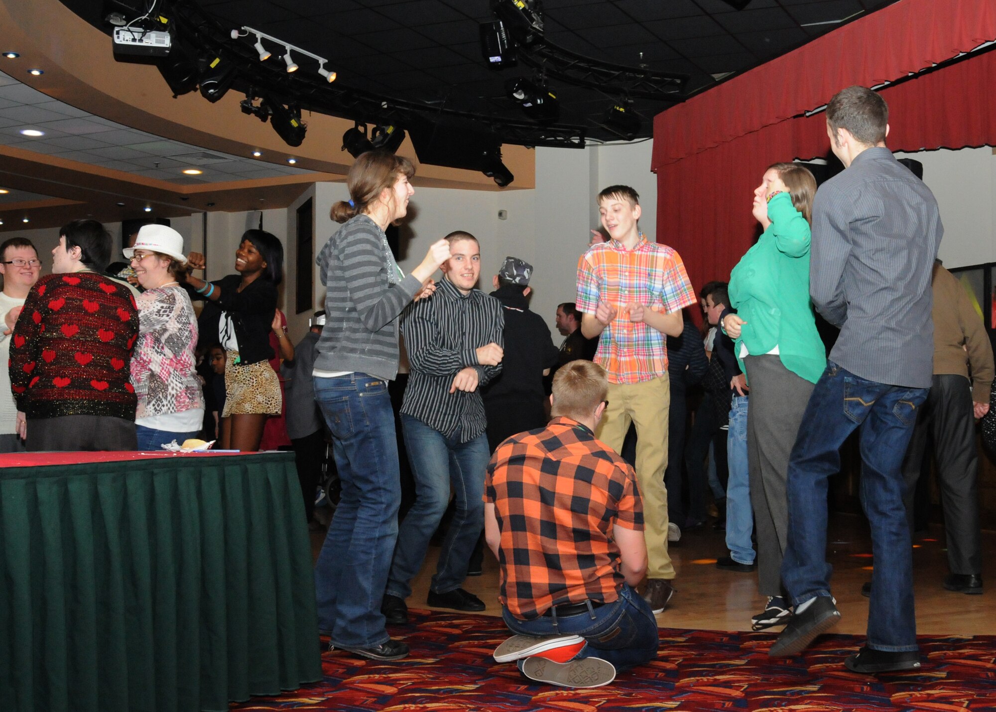 Teenage attendees of the Air Force Sergeants Association Special Needs Christmas Party dance to the song “Gangnam Style” Dec. 15, 2012, at RAF Mildenhall, England. Volunteers from both RAF Lakenheath and RAF Mildenhall ran the event. (U.S. Air Force photo by Tech. Sgt. Neal X. Joiner/Released)
