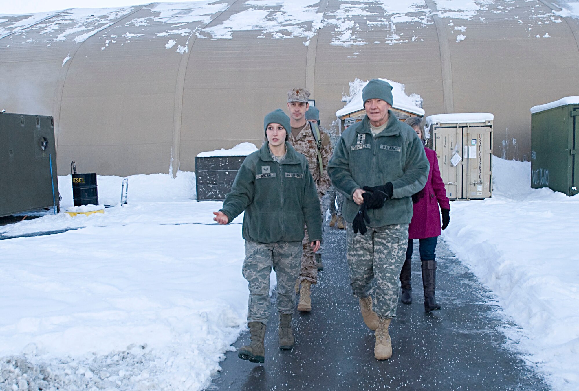 Left to right, Senior Airman Ashley Nolan, 376th Expeditionary Logistics Readiness Squadron passenger services representative, provides a tour of the passenger terminal luggage yard to U.S. Army Gen. Martin Dempsey, Chairman of the Joint Chiefs of Staff, during the USO holiday tour at Transit Center at Manas, Kyrgyzstan, Dec. 14, 2012.  Nolan briefed Dempsey on her daily duties and local procedures at the Transit Center.  (U.S. Air Force photo / Staff Sgt. Stephanie Rubi) 