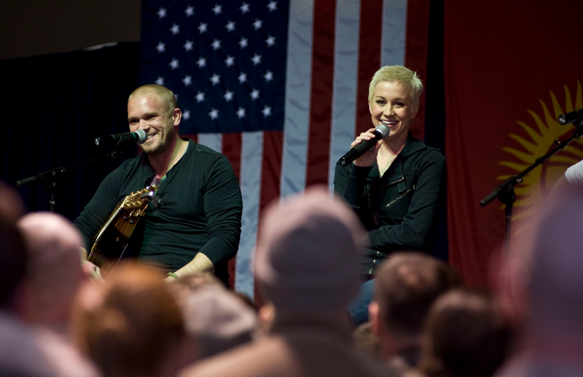 Kellie Pickler, an American country music artist, and husband Kyle Jacobs, laughs with U.S. troops during the USO holiday tour at Transit Center at Manas, Kyrgyzstan, Dec. 14, 2012. Pickler visited with U.S. troops during a tour of the Transit Center prior to the show and stayed late to sign autographs and pose for photos with fans. (U.S. Air Force photo / Staff Sgt. Stephanie Rubi) 