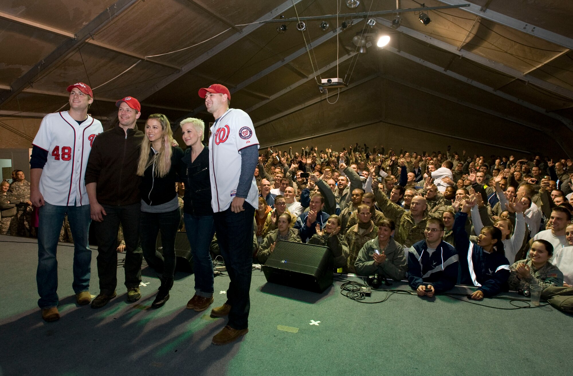 Members of the USO holiday tour pose for photos infront of nearly 500 U.S. troops at Transit Center at Manas, Kyrgyzstan, Dec. 14, 2012. The tour show-cased IIiza Shlesinger, a winner of NBC?s last comic standing, Craig Stammen and Ross Detwiler of Major League Baseball?s Washington Nationals, Matt Hendricks of National Hockey League?s Washington Capitals, and Kellie Pickler, an American country music artist. (U.S. Air Force photo / Staff Sgt. Stephanie Rubi)