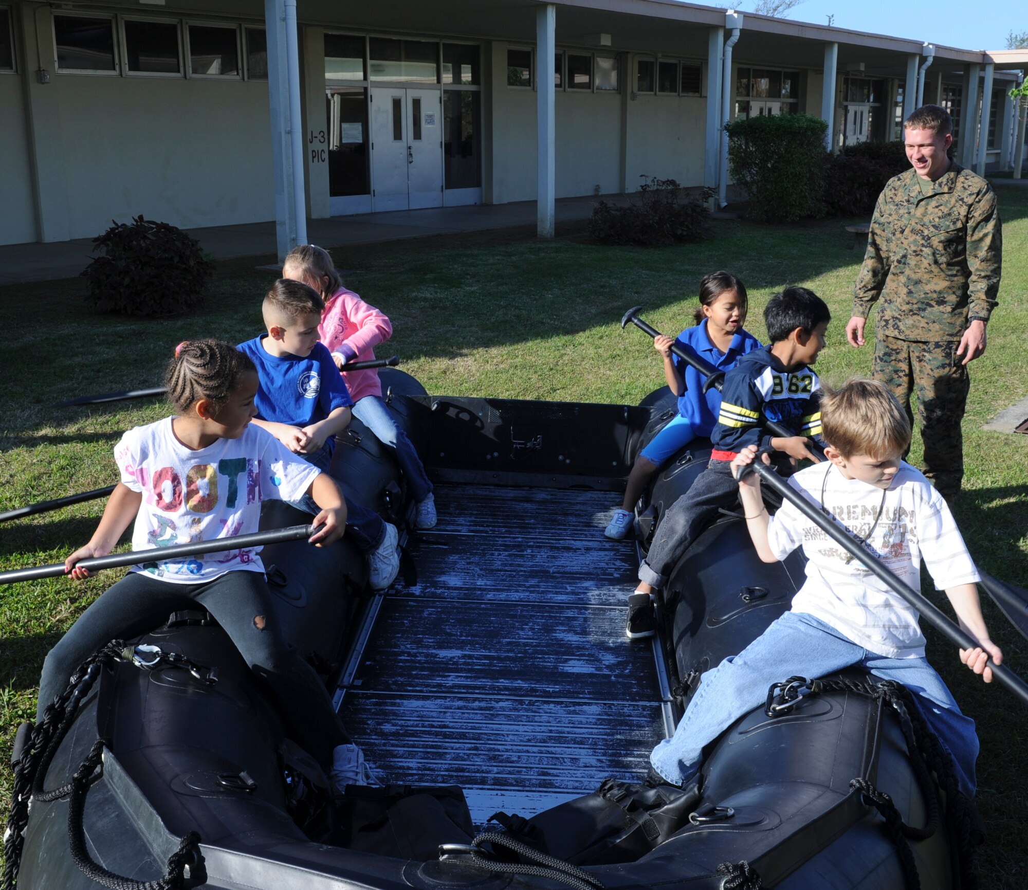 Students from Kadena Elementary School, learn how to row a F-4 70 Zodiac boat, a rigid hull inflatable boat, during a diving demonstration on Kadena Air Base, Japan, Dec. 14, 2012. The second grade students are studying robotics in support of the Department of Defense Education Activity?s initiative of the science, technology, engineering, and math program. (U.S. Air Force photo/Airman 1st Class Justin Veazie)