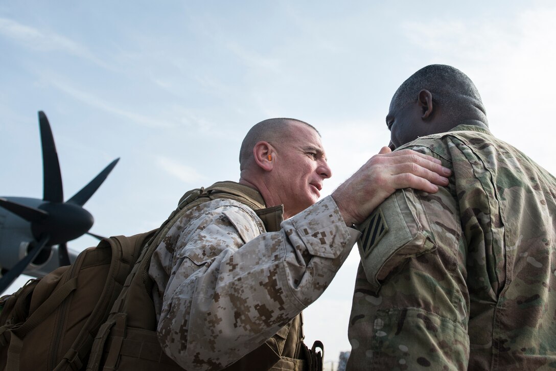U.S. Army Command Sgt. Maj. Edd Watson, the command sergeant major of the 3rd Infantry Division and Regional Command South, greets U.S. Marine Corps Sgt. Maj. Bryan Battaglia, senior enlisted advisor to the chairman of the Joint Chiefs of Staff, at Zagabad Forward Operating Base, Afghanistan, Dec. 16, 2012.  