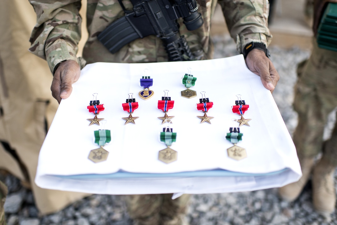 Medals are prepared for Army Gen Martin E. Dempsey, chairman of the Joint Chiefs of Staff, to present to soldiers deployed at Forward Operating Base Azim Jan Karez, Afghanistan, Dec. 16, 2012.  