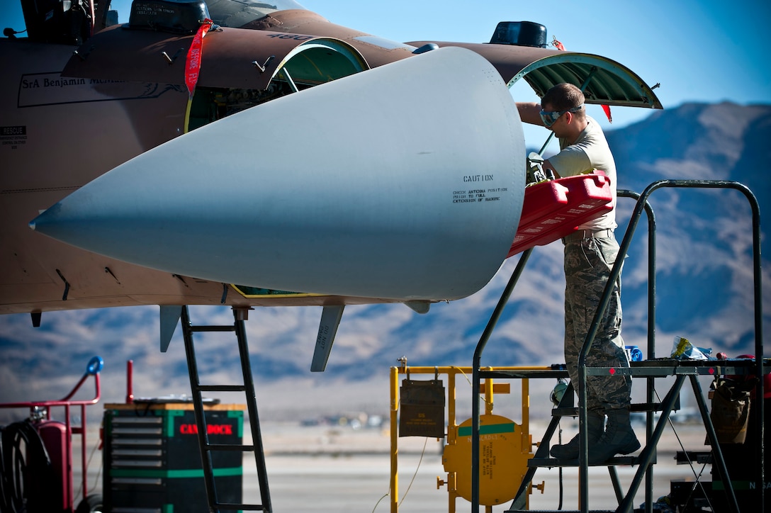 Air Force Senior Airman Brion Humenay works on the nose of an F-15 Eagle during a mission employment phase exercise on Nellis Air Force Base, Nev., Dec. 7, 2012. Mays, an avionics specialist, is assigned to the 926th Aircraft Maintenance Squadron.