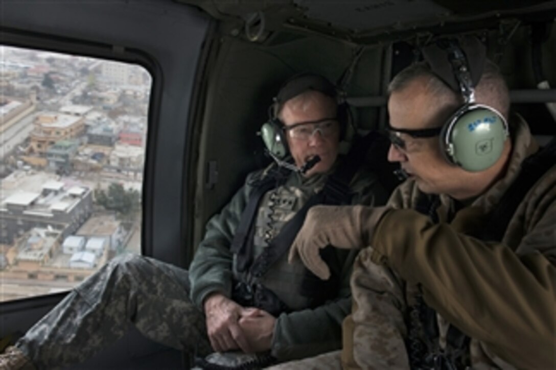 Chairman of the Joint Chiefs of Staff Gen. Martin E. Dempsey, left, listens to Commander, International Security Force, Afghanistan Gen. John Allen as they fly over Bagram, Afghanistan, on Dec. 15, 2012.  