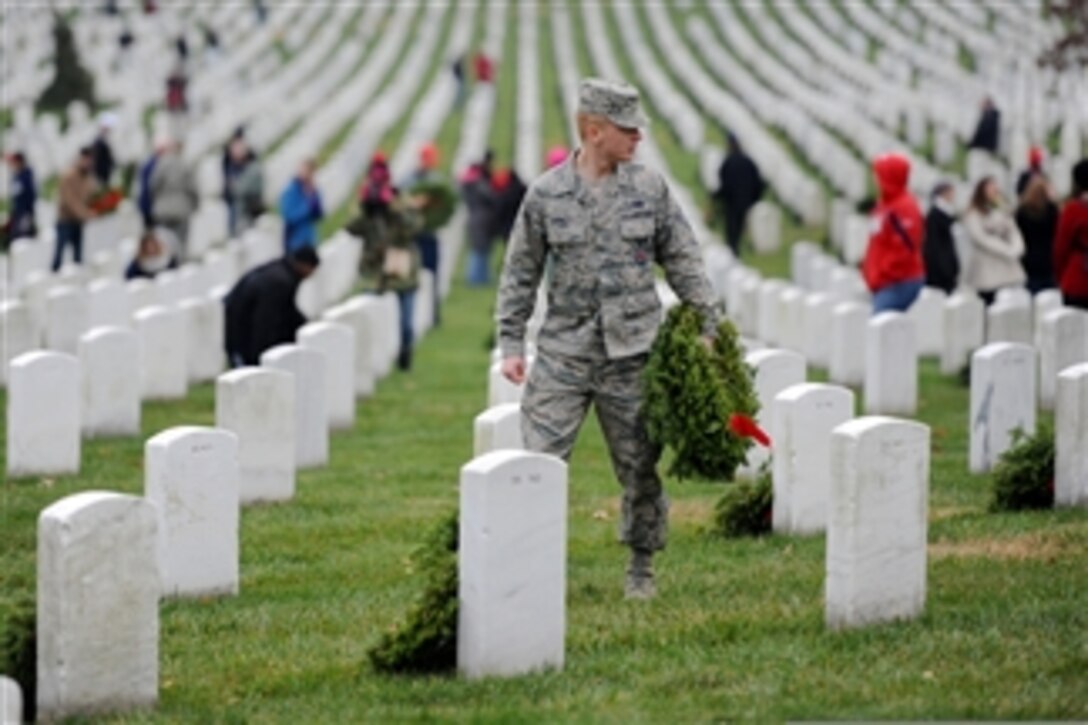 U.S. Air Force Airman 1st Class Colton carries wreaths at Arlington National Cemetery during a Wreaths Across America event in Arlington, Va., on Dec. 15, 2012. Colton was among thousands of volunteers that helped place 110,000 wreaths at the graves of fallen service members as part of the annual Wreaths Across America event. Burnett is attached to the 11th Civil Engineering Squadron at Joint Base Andrews, Md.  