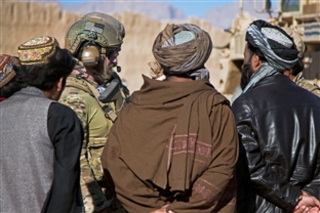 A coalition force member speaks with Afghan local police in a village in Farah province, Afghanistan, Dec. 11, 2012. Coalition forces were conducting a patrol to assess the Afghan local police in the village. 