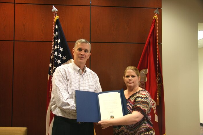Andrew Dwyer, Program Manager for Global Combat Support Systems-Marine Corps, presents Amy Mersereau-Cooper with the President's Volunteer Service Award, Dec. 7th, 2012. This is Mersereau-Cooper's second award, making her a Bronze-level award recipient.
