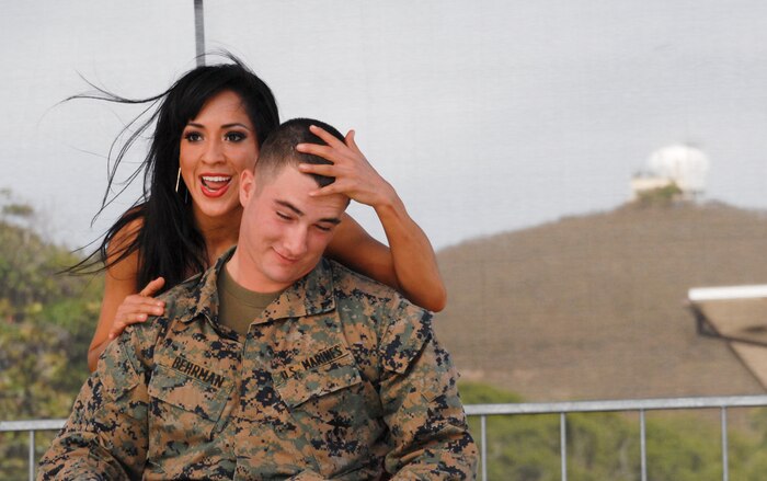 MARINE CORPS BASE HAWAII - Lance Cpl. Chase Behrman, amphibious assault vehicle operator, Combat Assault Company, 3rd Marine Regiment, is featured onstage as pop singer Kimberly Cole and her dancers perform during the Leatherneck Comedy and Entertainment Tour at Dewey Square, Dec. 12, 2012. The tour, sponsored by Headquarters Marine Corps, featured Cole and comedian Gabriel Iglesias. The single Marines and sailors aboard Marine Corps Base Hawaii received a free lunch provided by the Single Marine and Sailor Program on base, and entertainment by Cole and Iglesias. (Official U.S. Marine Corps photo by Kristen Wong)