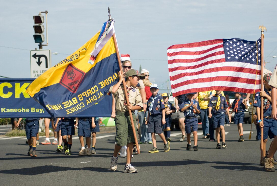 KANEOHE - Cub Scout Phillip Vargas, 10, of Cub Scout Pack 225, carries the troop flag during the 50th annual Kaneohe Christmas Parade, Dec. 1, 2012. To his right, Cub Scout Ty Freiburger, 9, carries the American flag. Many sons of Marines and sailors aboard Marine Corps Base Hawaii are part of Cub Scout Pack 225. The parade hosted approximately 1,800 marchers, 25 vehicles, 16 floats and eight bands. Local organizations, clubs, schools and churches participated. It started at Windward Mall on Haiku Road, and ended at Castle High School. (Official U.S. Marine Corps photo by Kristen Wong)