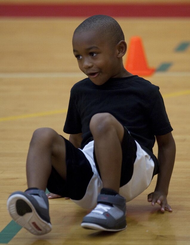 MARINE CORPS BASE HAWAII - Derrick Brown, 5, completes a crab walking drill while participating in High Intensity Tactical Training for Kids at Semper Fit Center, December 11. The class’s primary focus is to increase speed, quickness, and agility in conjunction with youth sports. (Official U.S. Marine Corps photo by Lance Cpl. Jacob D. Barber)