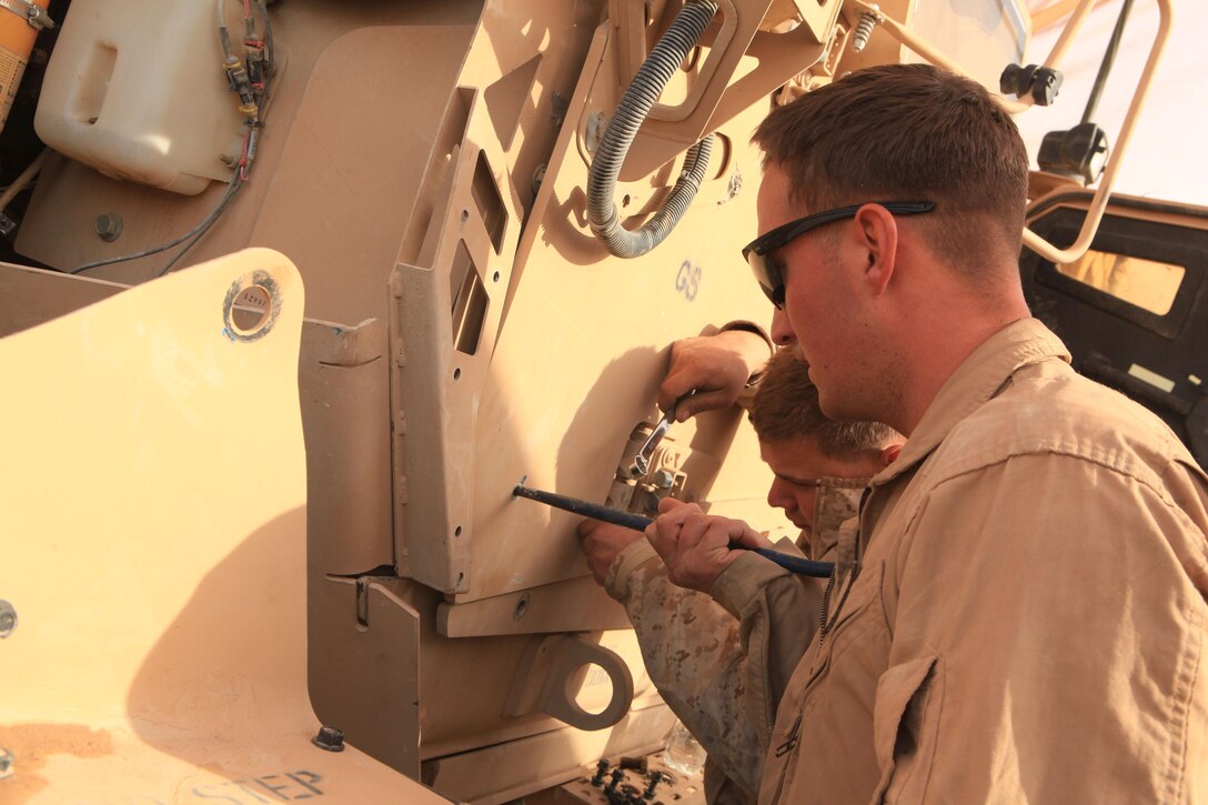 Marines with the motor transport section of Headquarters and Services Company, 2nd Battalion, 7th Marines, Regimental Combat Team 7, conduct vehicle maintenance on Combat Outpost Shamsher, Dec. 16, 2012. Vehicle maintenance is one of the many things COP Shamsher provides to the surrounding bases and districts in the battalion’s area of responsibility.