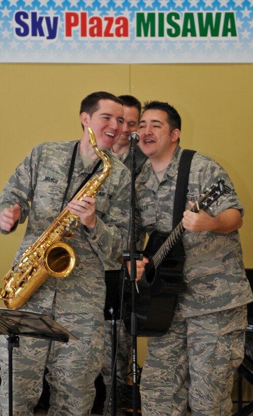 MISAWA, Japan -- Tech. Sgt. E. Justin Allen, right, Band of the Pacific-Asia vocalist and Senior Airman Greg Pflugh, left, Band of the Pacific-Asia saxophonist, sing during a performance by the USAF Band of the Pacific-Asia at the Misawa Sky Plaza, Misawa, Japan, on Dec. 12, 2012.  The group put together a show that could be enjoyed by Misawa Air Base military members and by local citizens.  (US Air Force Photo/Tech. Sgt. Phillip Butterfield)