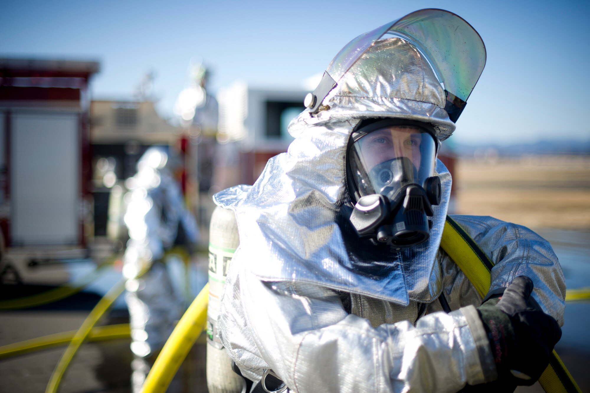YOKOTA AIR BASE, Japan-- Senior Airmen Aaron Tocco, a firefighter from the 374th Civil Engineer Squadron at Yokota Air Base, Japan, hold a water hose for fellow firefighters during a structural burn training exercise on Dec. 13, 2012. Firefighters handle hoses filled with 100 pounds of pressure while wearing 50 pounds of protective gear. (U.S. Air Force photo by Staff Sgt. Stacy Moless)