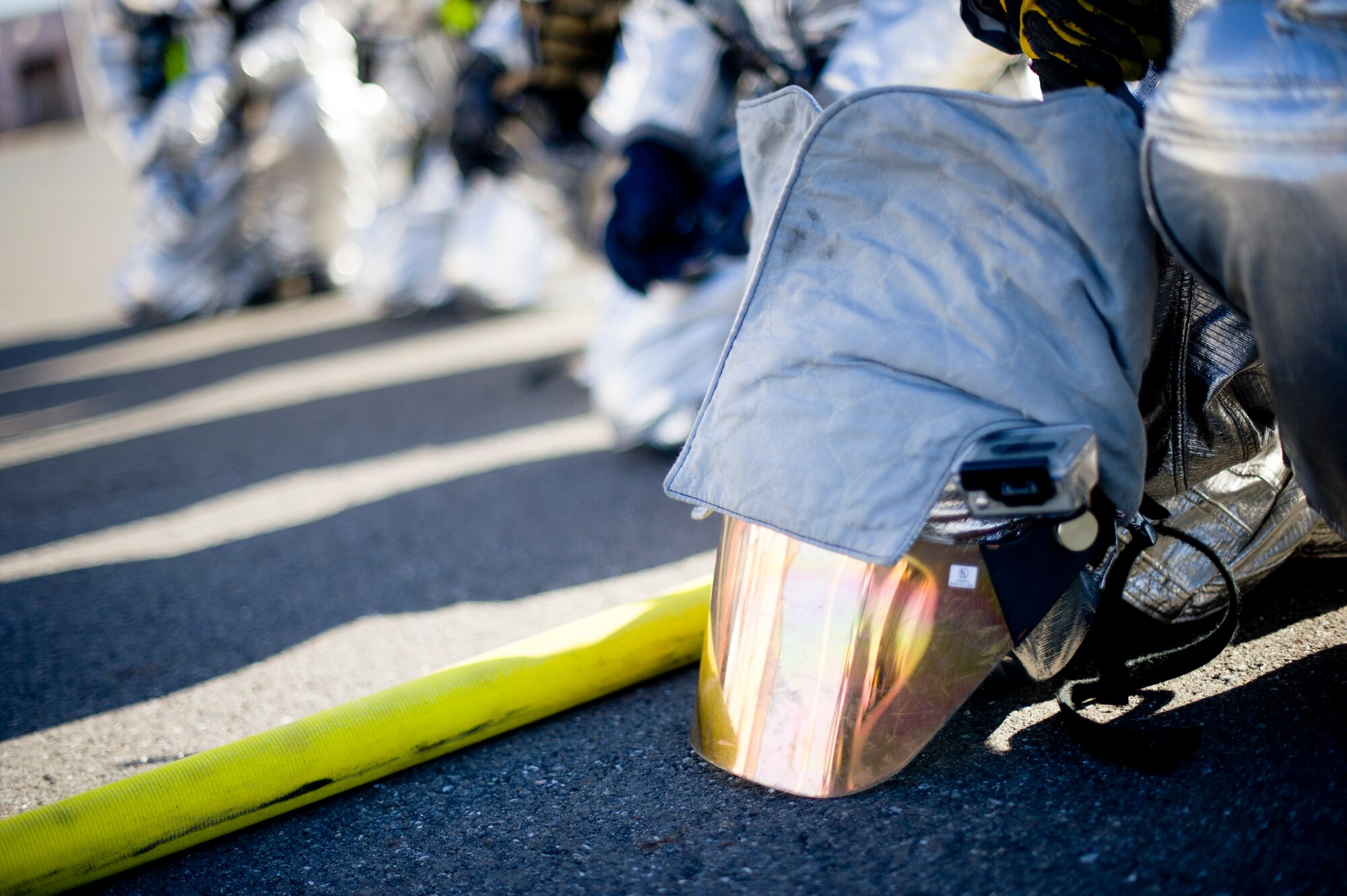 YOKOTA AIR BASE, Japan-- Firefighters from the 374th Civil Engineer Squadron at Yokota Air Base, Japan, wait for a structure used for fire training to catch on fire on Dec. 13, 2012. The firefighters participate in this type of training to keep their skills sharp so they are prepared to respond to fire emergencies. (U.S. Air Force photo by Staff Sgt. Stacy Moless)