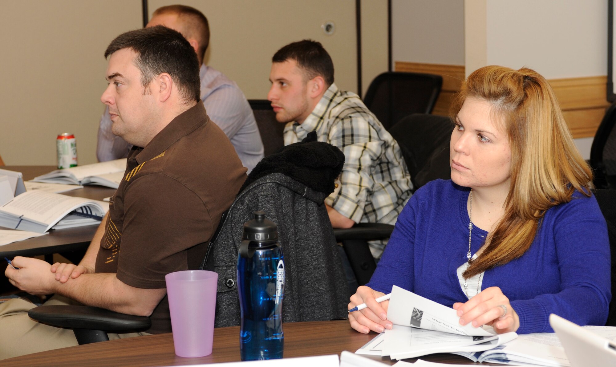 Staff Sgt. Karleigh Moss, 28th Comptroller Squadron financial analyst (right), listens to a Transition Assistance Program instructor talk about effective resume writing during a TAP class in the Airman and Family Readiness Center at Ellsworth Air Force Base, S.D., Dec. 13, 2012. The four-day class is required for Airmen who are separating and optional for retiring Airmen to help prepare them for different career, financial and educational situations as they prepare to move into civilian life. (U.S. Air Force photo by Airman Ashley J. Woolridge/Released) 
