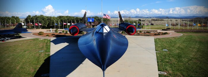 Flags fly at half-staff behind the SR-71 Black Bird static display at Heritage Park at Beale Air Force Base, Calif., Dec. 18, 2012. The flags will be at half-staff until Dec. 18, 2012, in honor of slain students from Sandy Hook Elementary School, Conn. (U.S. Air Force photo by Senior Airman Shawn Nickel/Released)