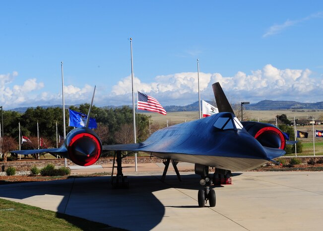 Flags fly at half-staff behind the SR-71 Black Bird static display at Heritage Park at Beale Air Force Base, Calif., Dec. 18, 2012. The flags will be at half-staff until Dec. 18, 2012, in honor of slain students from Sandy Hook Elementary School, Conn. (U.S. Air Force photo by Senior Airman Shawn Nickel/Released)