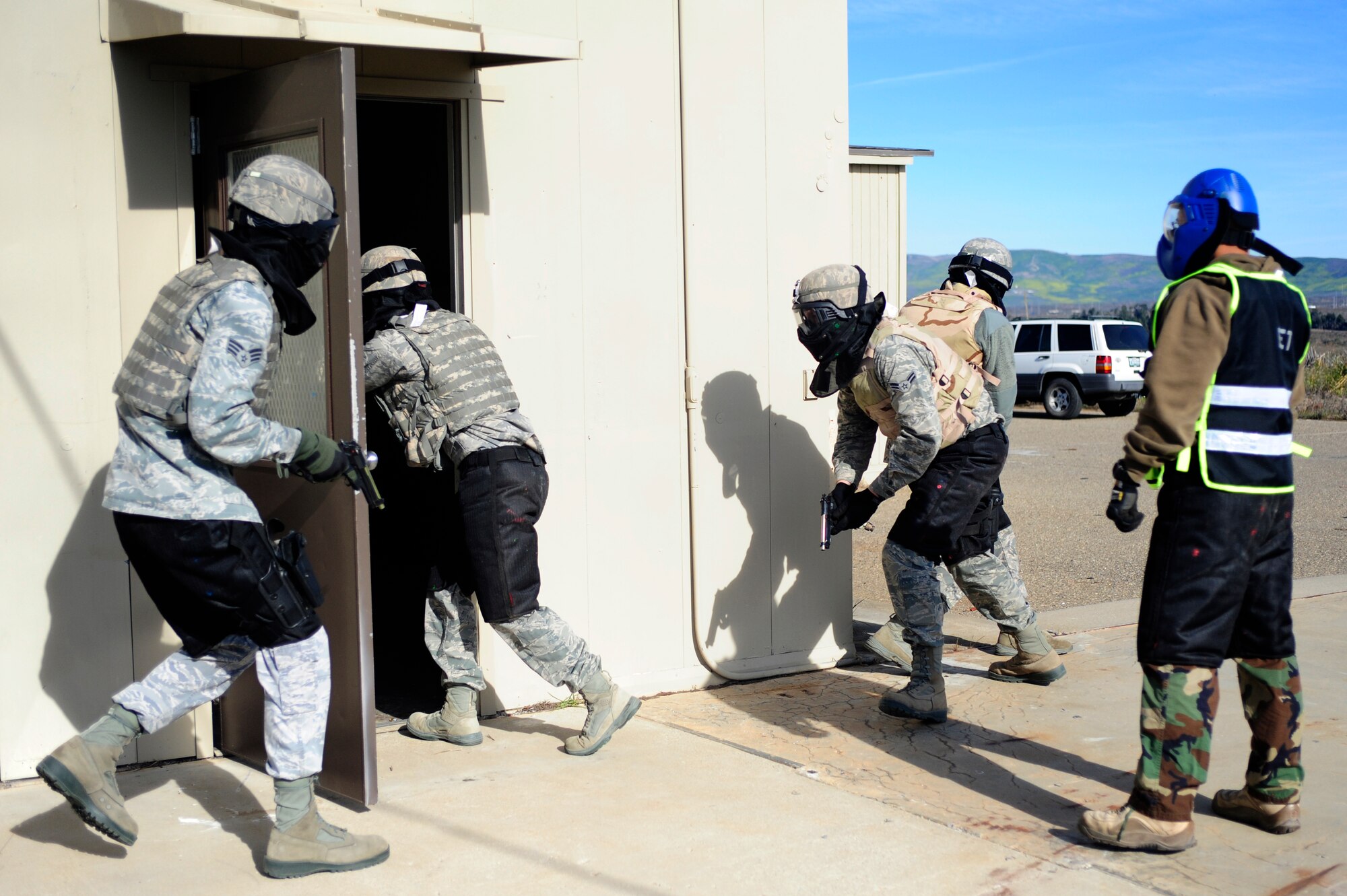 VANDENBERG AIR FORCE BASE, Calif. -- Christopher Baltazar, 30th Security Forces Squadron trainer, observes the trainee's tactics during an active shooter training course here Thursday, Feb. 2, 2012. The 30th SFS use their experience to show a spectrum of incidents that can occur and how to operate effectively in any environment. (U.S. Air Force photo/Staff Sgt. Andrew Satran) 