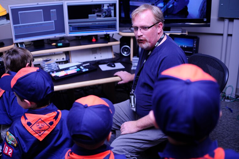 VANDENBERG AIR FORCE BASE, Calif. -- Michael Stonecypher, a 30th Space Wing Public Affairs Office broadcaster, teaches Vandenberg Cub Scout Pack 102 about live broadcasts in the editing room during the scouts visit to the Public Affairs Office here Wednesday, Feb. 1, 2012. Stonecypher showed how a broadcast is performed during launch operations. (U.S. Air Force photo/Staff Sgt. Andrew Satran) 