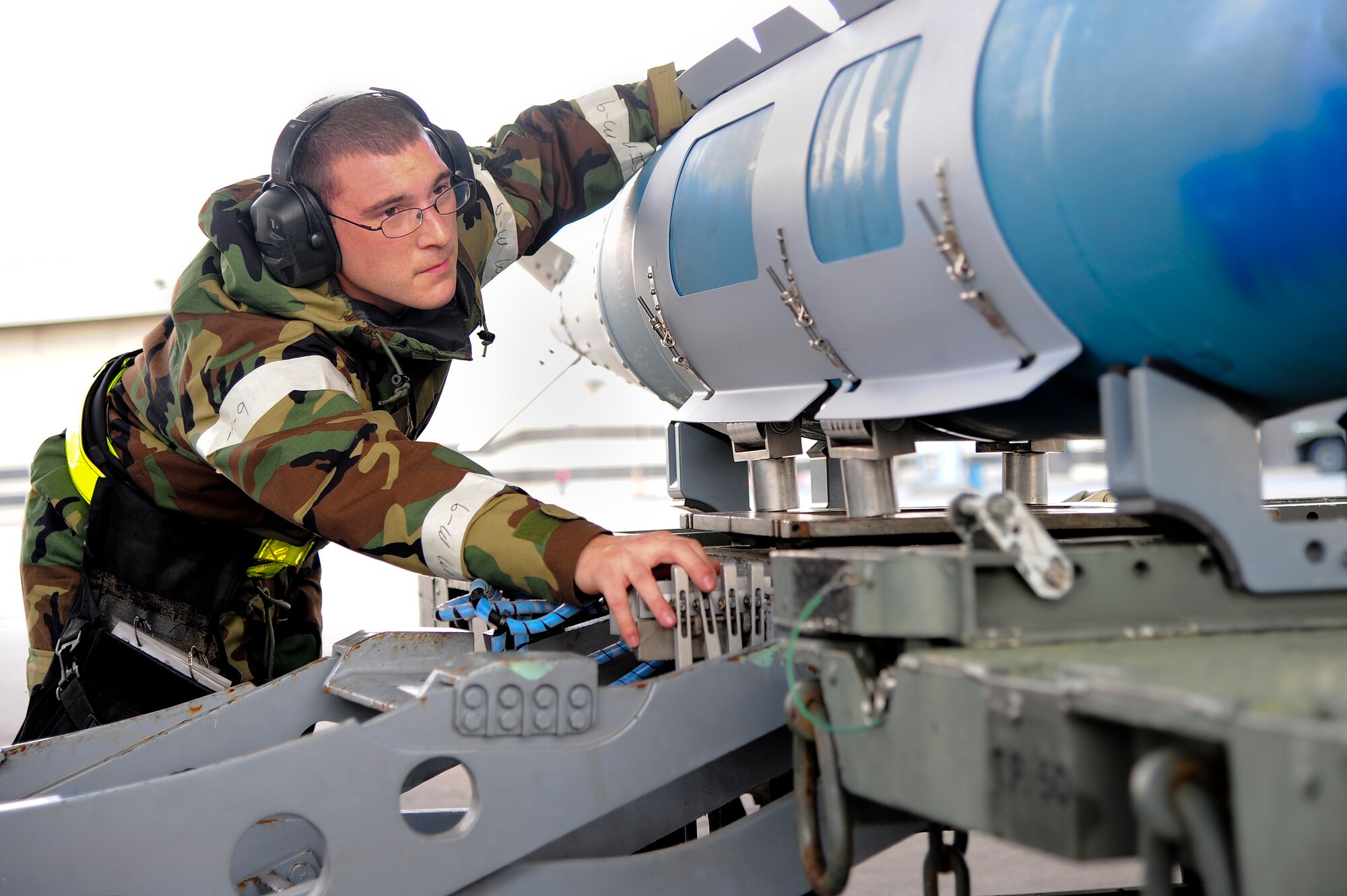 U.S. Air Force Staff Sgt. Daniel Farris, 336th Aircraft Maintenance Unit weapons load crew team chief, guides a GBU-31 missile into position during Operational Readiness Exercise Coronet Warrior 12-06 on Seymour Johnson Air Force Base, N.C., Dec. 18, 2012. Airmen emphasized their ability to employ and sustain forces in a deployed environment during the ORE. (U.S. Air Force photo/Airman 1st Class Aubrey White/Released)