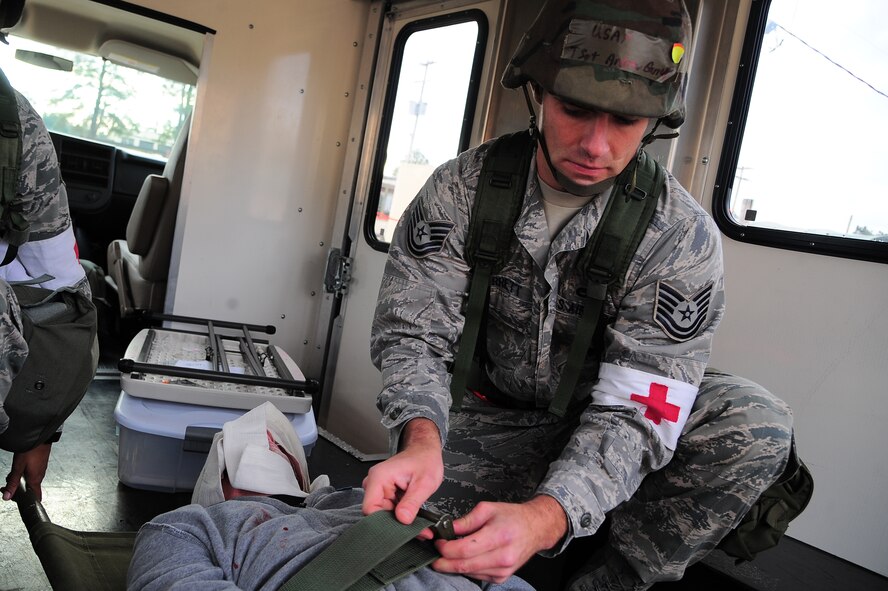 U.S. Air Force Tech. Sgt. Andrew Garrett, 4th Medical Support Squadron medic, tightens the strap on a litter during Operational Readiness Exercise Coronet Warrior 12-06, at a simulated deployed location on Seymour Johnson Air Force Base, N.C., Dec. 18, 2012. Medics must ensure their patient is secure on the litter prior to transportation to the hospital. (U.S. Air Force photo/Airman 1st Class Aubrey White/Released)