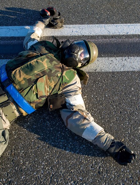 Staff Sgt. Shaun Tucker, 436th Maintenance Group, is sprawled out on the flightline as a simulated casualty during a training exercise Dec. 13, 2012, at Dover AFB, Del. In the background is a C-17A Globemaster III. The 436th Maintenance Group conducted a training exercise to evaluate the deployment preparedness levels of its Airmen. Dover is home to the 436th Airlift Wing which operates both C-5 Galaxy and C-17A Globemaster III aircraft. (U.S. Air Force photo by Greg L. Davis)
